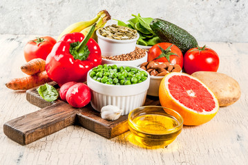 Healthy food background, trendy Alkaline diet products - fruits, vegetables, cereals, nuts. oils, light concrete background