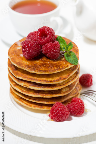 stack of pancakes with fresh raspberries for breakfast, vertical top view