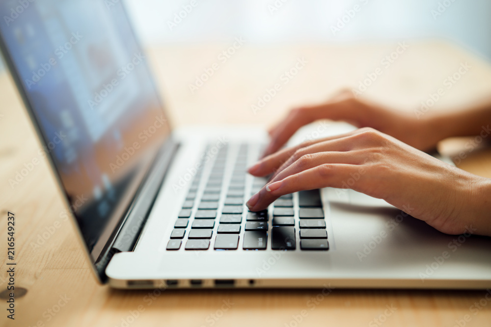 Woman hands typing on laptop keyboard at the office, Woman worker and business concept, Soft focus on vintage wooden table. Woman hands typing on laptop keyboard at the office, Woman worker and business concept, Soft focus on vintage wooden table.