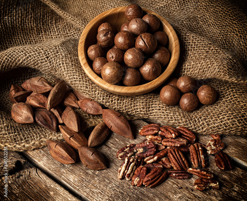 Macadamia, Pecan and Pili nuts on wooden table