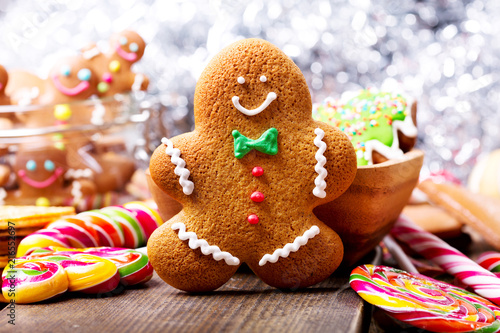 Christmas homemade gingerbread man and sweets on wooden table