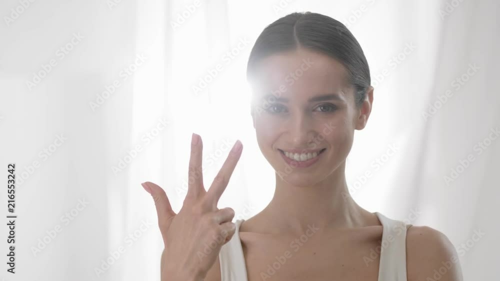 Attractive Woman Counting To Five On Fingers