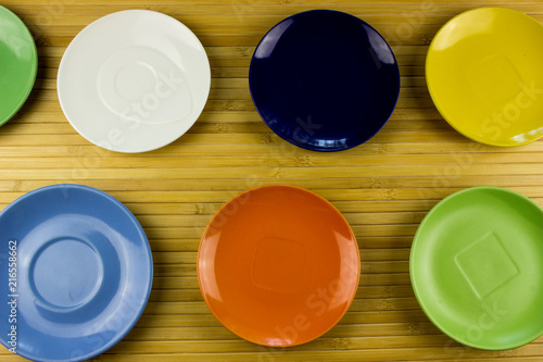 Color empty plates on a table. Food and restaurant concept