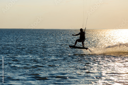 professional kiter doing a complicated trick on a beautiful sunset background