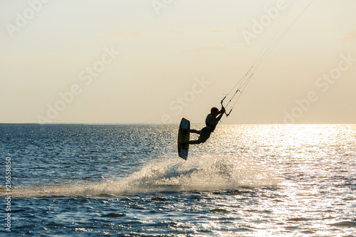 professional kiter doing a complicated trick on a beautiful sunset background