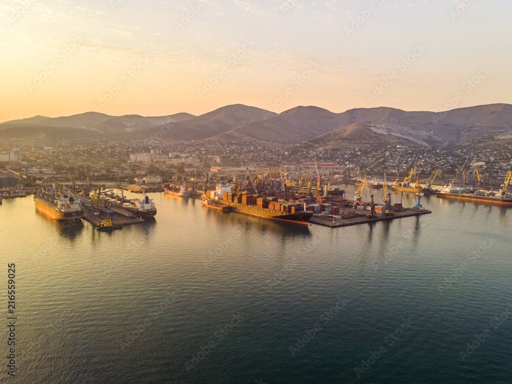 Container ship in import export and business logistics, By crane, Trade Port, Shipping cargo to harbor, Aerial view from drone, International transportation, Business logistics concept Container ship in import export and business logistics, By crane, Trade Port, Shipping cargo to harbor, Aerial view from drone, International transportation, Business logistics concept