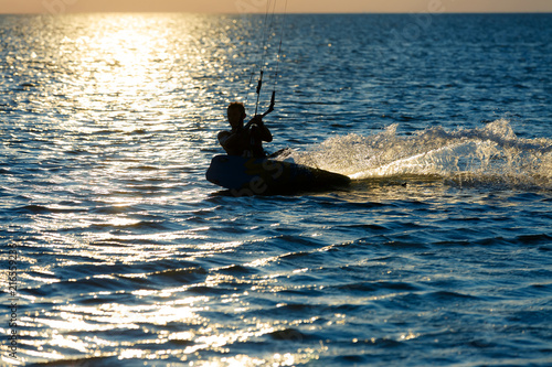 professional kiter doing a complicated trick on a beautiful sunset background