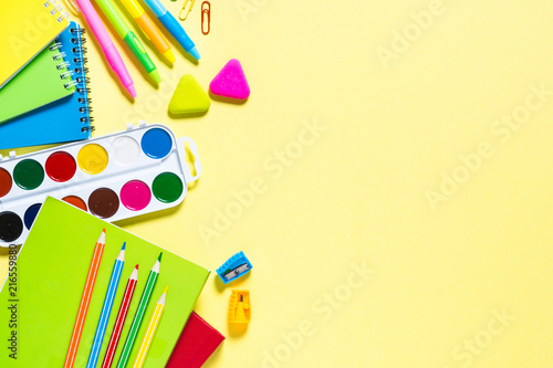 School and office sstationery on yellow background.  photo