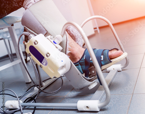 Patient on CPM (continuous passive range of motion) machines. Device to provide anatomically correct motion to both the ankle and subtalar joints. photo