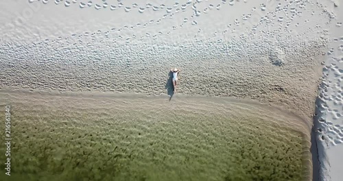 Girl lay on beach in Lencois Maranhenses Maranhao Brazil