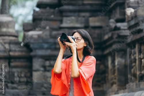 Asian female solo travelers and take photo ancient buildings- Borobudur temple- Java -Indonesia- Asia.