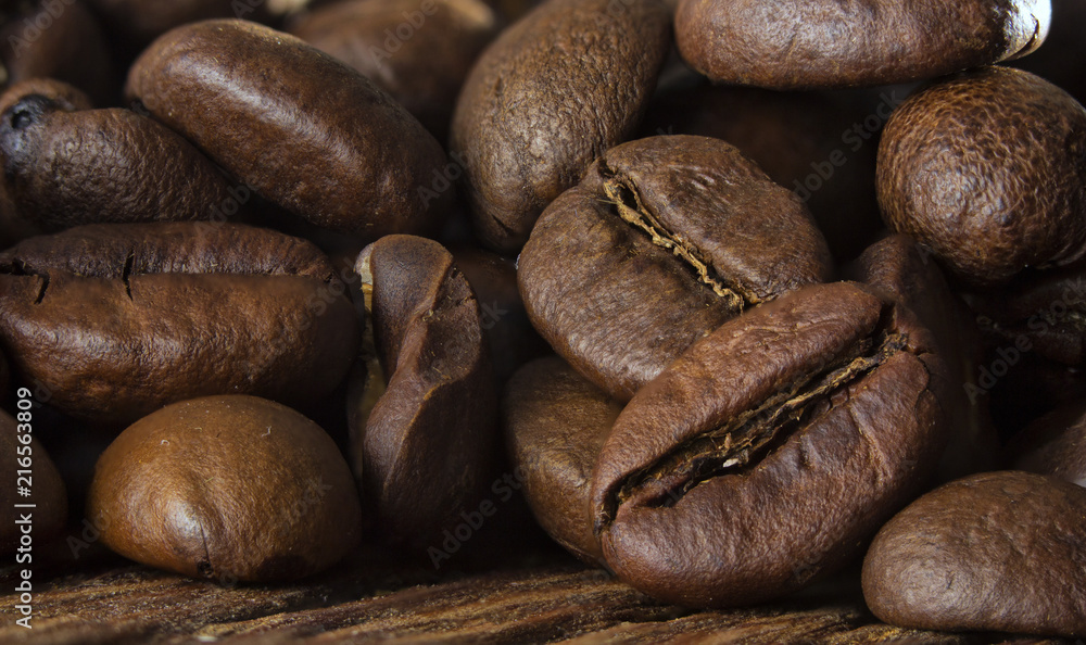 Fototapeta premium Coffee seeds on grunge wooden background