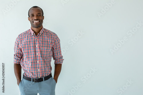 Cheerful afro american man smiling against white background