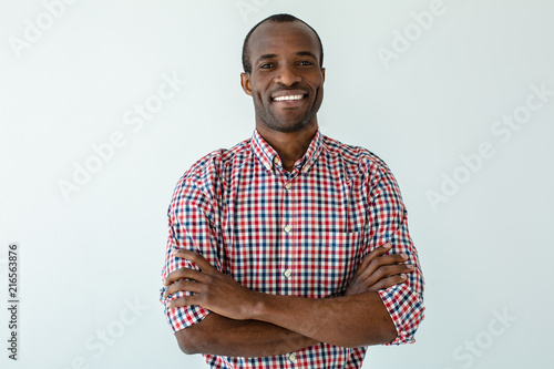 Joyful afro american man folding his hands