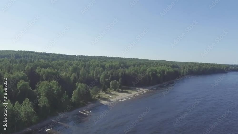 Aerial scenic of side flight above lake shore in forest, unsaturated Aerial scenic of side flight above lake shore in forest, unsaturated