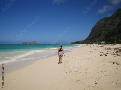 woman walking at Waimanalo beach Oahu island hawaii