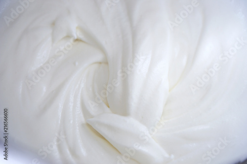 close up of a white whipped or sour cream on white background.
