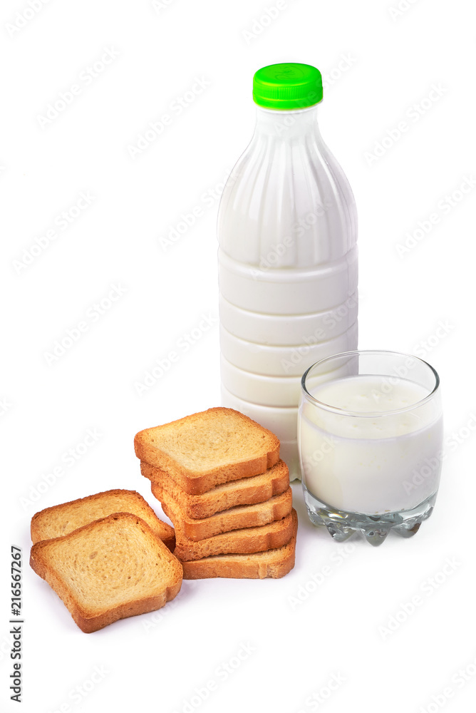 A bottle of milk and glass of milk with crispy toasters. Мorning meals. Isolated on white background. A bottle of milk and glass of milk with crispy toasters. Мorning meals. Isolated on white background.