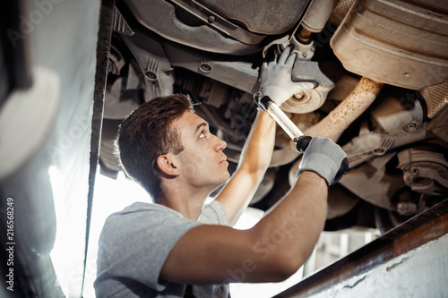 Safety first: an automechanic is conducting a detailed examinati photo