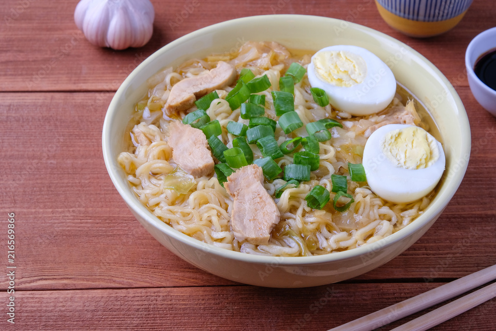 Chinese chicken soup. Cooked in a wok.Wooden background. Chinese chicken soup. Cooked in a wok.Wooden background.