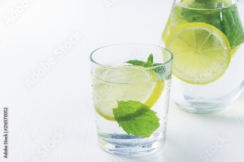 Lemonade with fresh lemon. Lemon water.