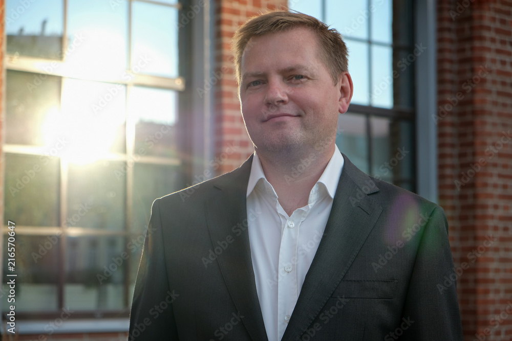 Portrait of middle aged confident businessman at the office, outside, sunshine Portrait of middle aged confident businessman at the office, outside, sunshine