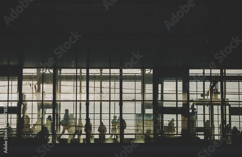 Photography Black sillhouettes of people waiting for their train on a subway station behind