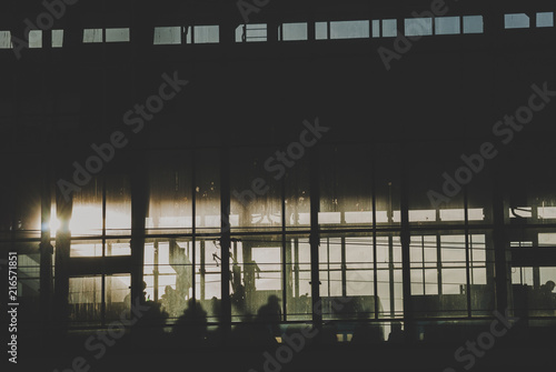 Photography Black sillhouettes of people waiting for their train on a subway station behind