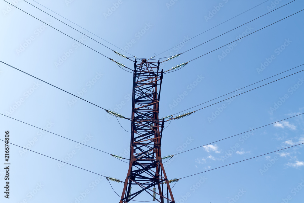Electric pylon against the backdrop of the blue sky on a summer day Electric pylon against the backdrop of the blue sky on a summer day