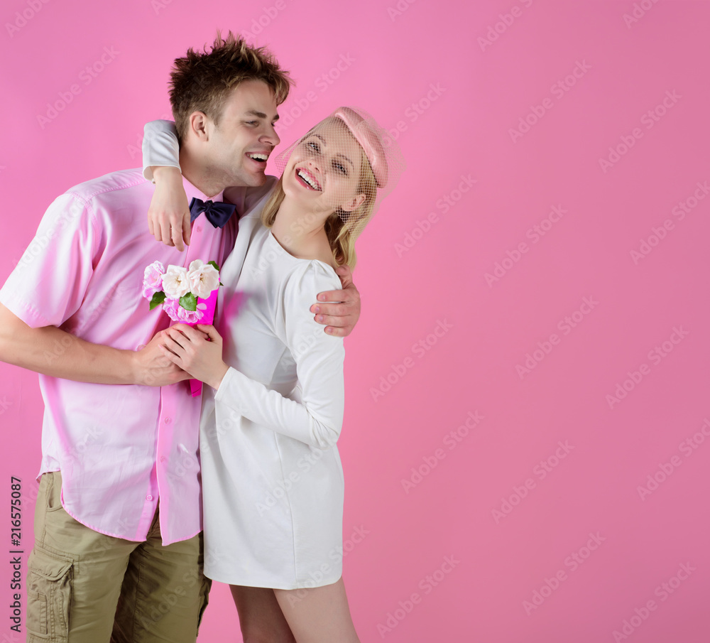 Smiling couple. Date. Happy couple hugging. Relationship and family concept. Woman with flower on date. Isolated on pink background. Appointment. Meeting. Rendezvous. Valentines Day. Smiling couple. Date. Happy couple hugging. Relationship and family concept. Woman with flower on date. Isolated on pink background. Appointment. Meeting. Rendezvous. Valentines Day.