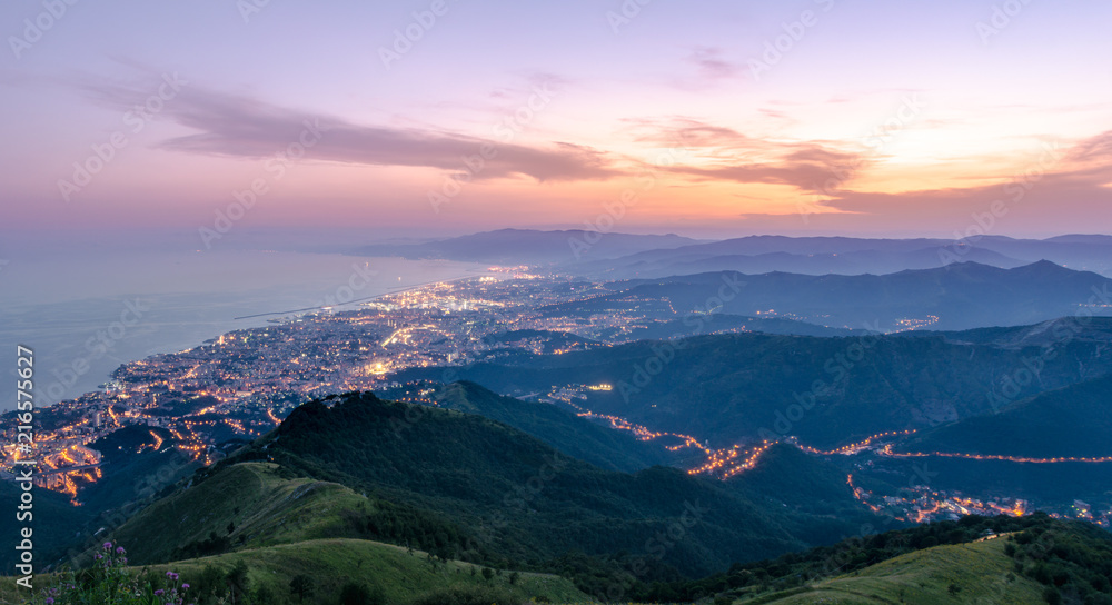 Panoramic image at golden hour, mountain, city and ocean frame