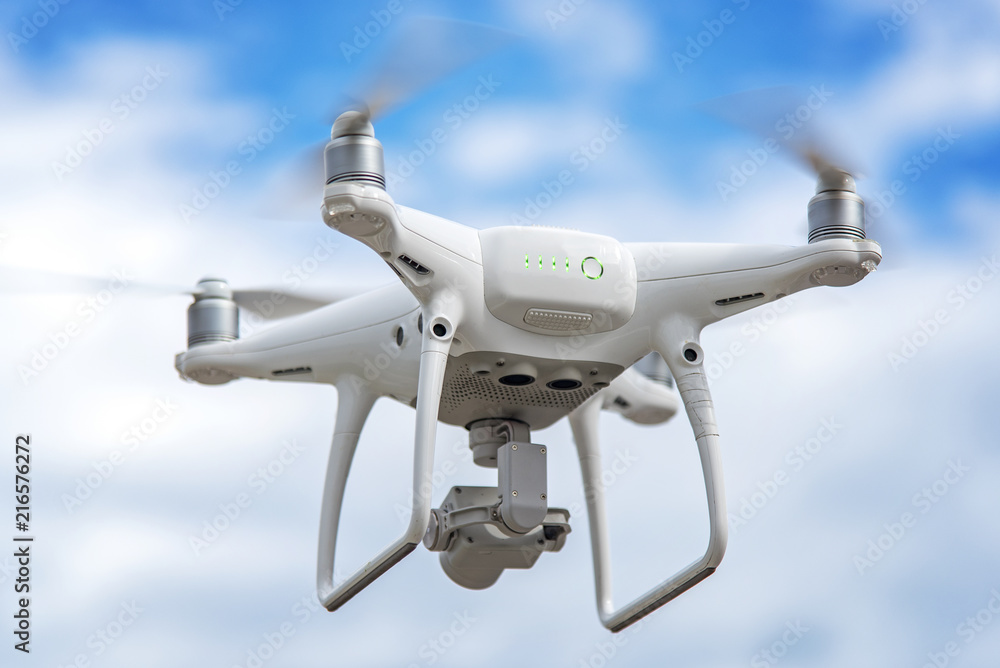 Remotely controlled drone hovering in the air, making some video footage of the city Remotely controlled drone hovering in the air, making some video footage of the city