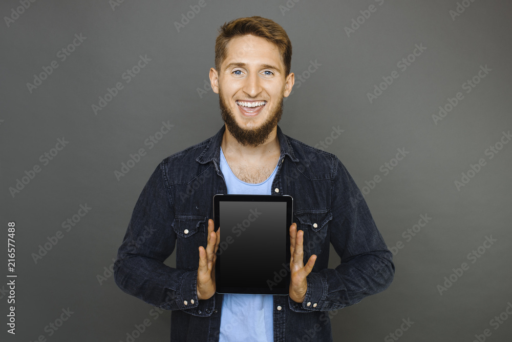 Cheerful guy demonstrating tablet Cheerful guy demonstrating tablet