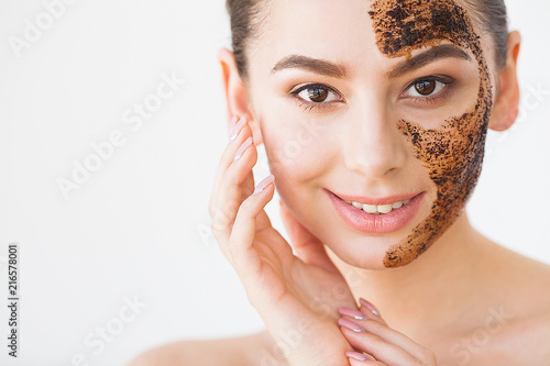 Face Skincare. Young Charming Girl Makes a Black Charcoal Mask on Her Face