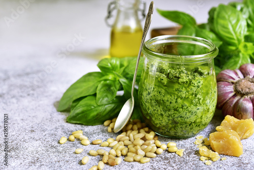 Homemade sauce pesto in a vintage jar with ingredients for making.