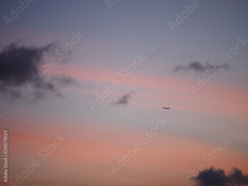 pink purple sunset sky clouds with airplane silhouette 