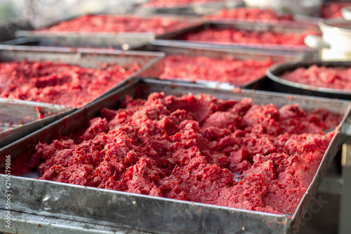 Close-up detail traditional handmade tomato paste making process shot under open air