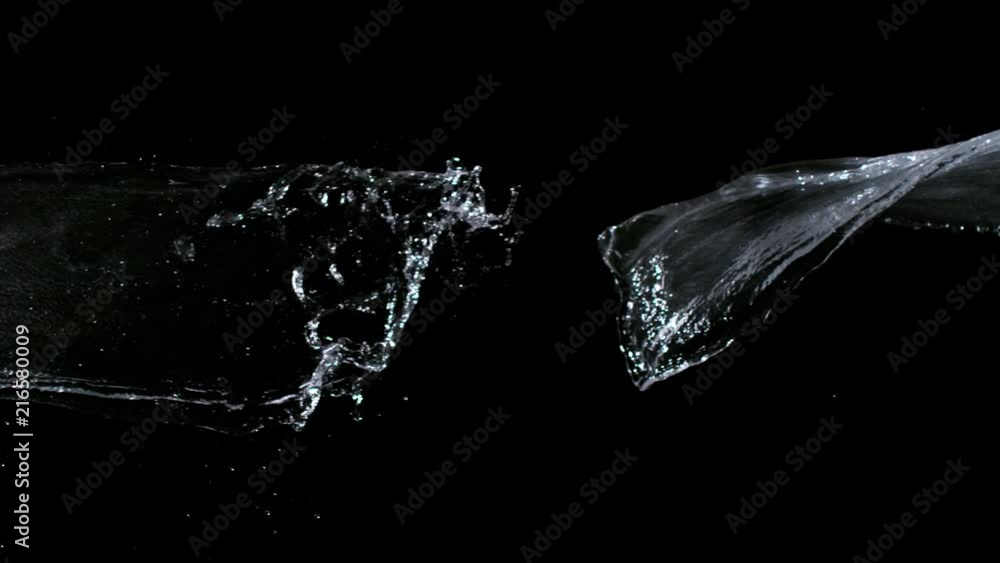 Super slow-motion shot of water splash against black. Shooted with high speed cinema camera at 1000fps Super slow-motion shot of water splash against black. Shooted with high speed cinema camera at 1000fps
