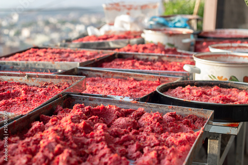 Close-up traditional handmade tomato paste plates making process shot under open air