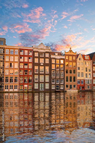 Traditional old buildings and boats in Amsterdam, Netherlands. Canals of Amsterdam.