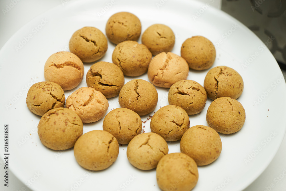 Cookies and sweet biscuits on white plate background, top view 