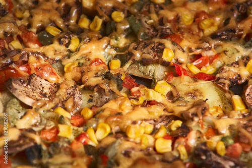 baked casserole with potato, mushrooms,onion, tomatoes and cheese on baking sheet. Selective focus