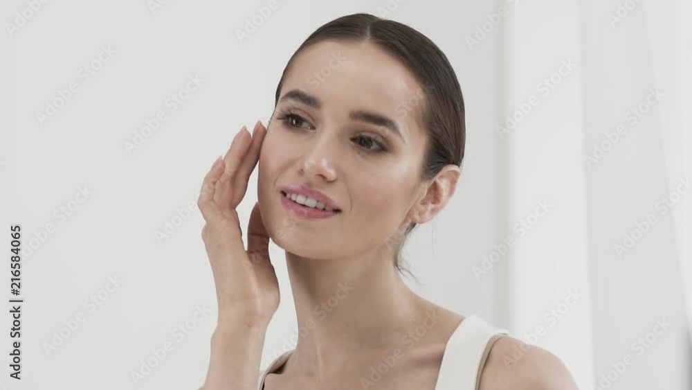 Beauty Care. Attractive Smiling Woman Caressing Face Skin Beauty Care. Attractive Smiling Woman Caressing Face Skin
