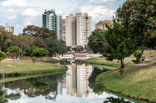 Buildings reflected on the water of a river, in the Ecological Park, in Indaiatuba, Brazil.