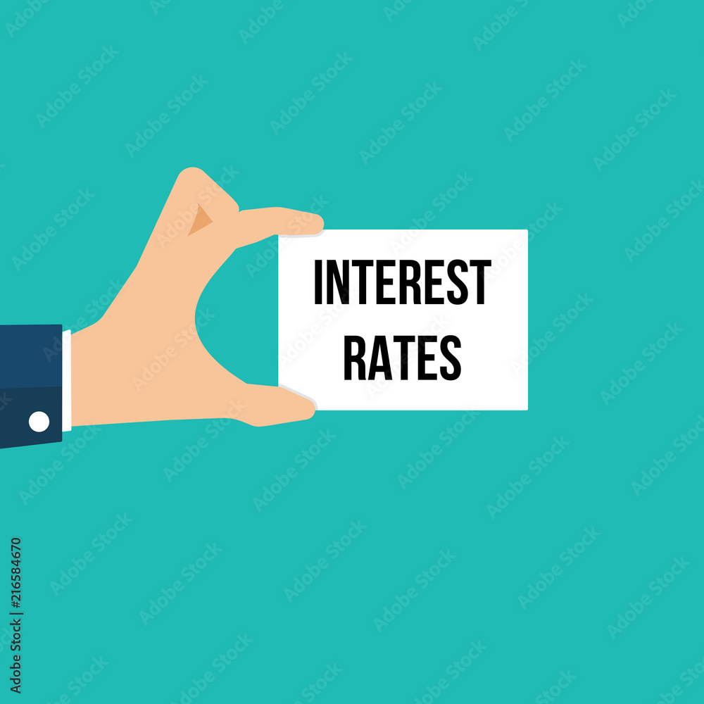 Man showing paper INTEREST RATES text Man showing paper INTEREST RATES text