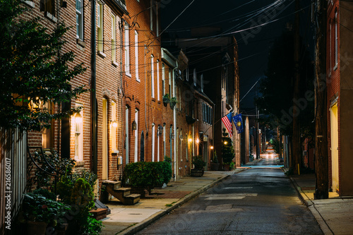 American flag and row houses on Bethel Street at night  in Fells Point  Baltimore  Maryland