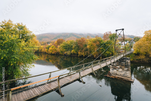 Swinging bridge over the James River and fall color in Buchanan, Virginia