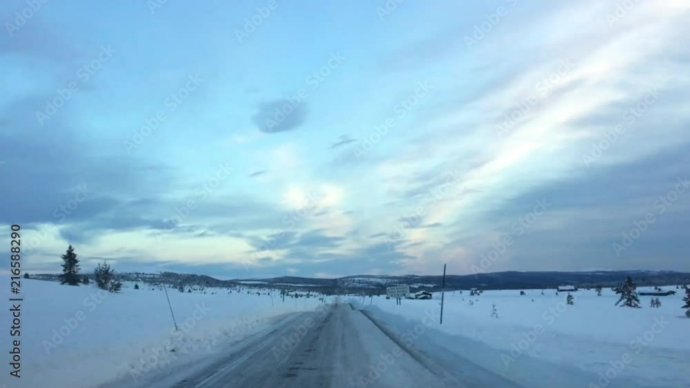 The video is taken from a moving machine. View of the road and snowdrifts in Norway. The video is taken from a moving machine. View of the road and snowdrifts in Norway.