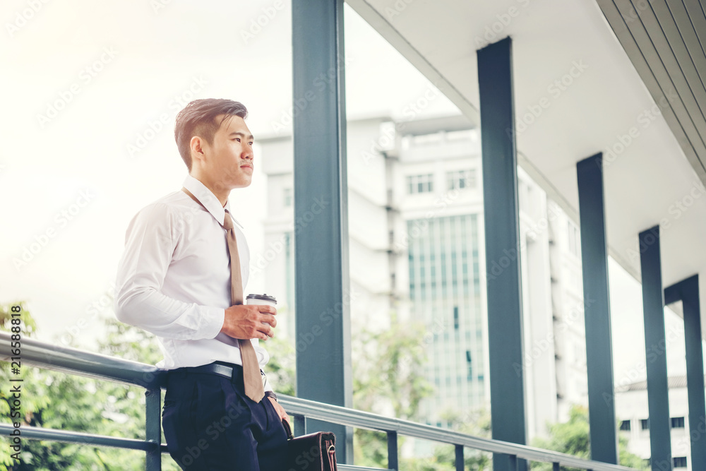 Businessman drinking a coffee and looking view and thinking success Businessman drinking a coffee and looking view and thinking success
