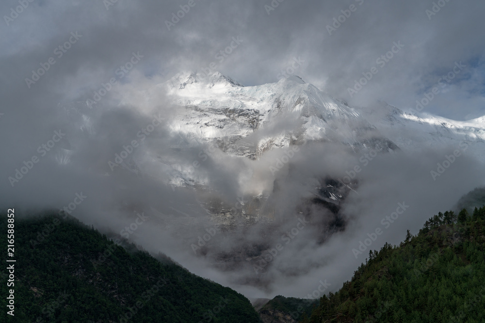 Annapurna II peaks out behind some clouds
